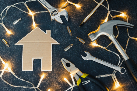 do it yourself and home renovation concept: set of DIY tools and little cardboard houseの写真素材