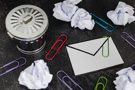 envelope with clip symbol of email and attachments with trash can next to it, concept of spam and...
