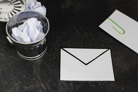 envelope with clip symbol of email and attachments with trash can next to it, concept of spam and unwanted emailsの写真素材