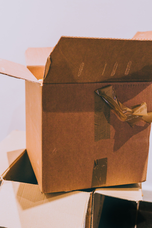 two opened cardboard boxes stacked on top of each other, concept of heavy delvery or moving houseの写真素材