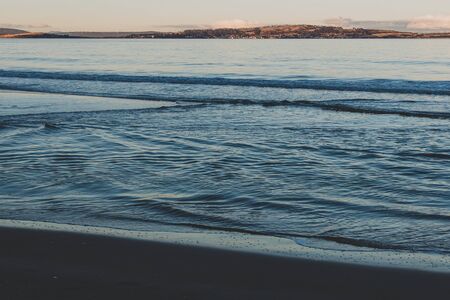 view of the water on a Tasmanian beach in South Hobart at dusk