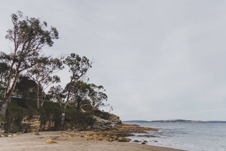 Seven Mile beach in Tasmania, Australia looking deserted n an overcast winter dayの写真素材