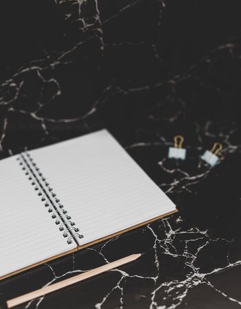 back to work concept: desk with mixed stationery items and notebook for future projects or tasksの写真素材