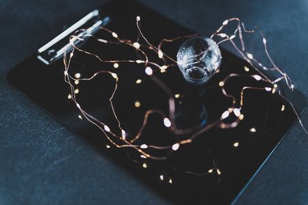 light bulb on clipboard surrounded by string lights, concept of new ideas at workの写真素材
