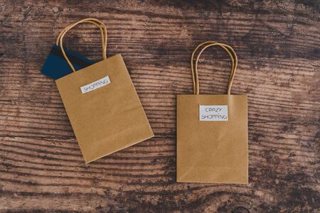 flatlay with shop bags with labels, concept of crazy or intentional shopping