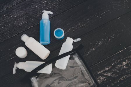 set of lotions and moisturizers popping out of transparent pouch, concept of spa and pamperingの写真素材