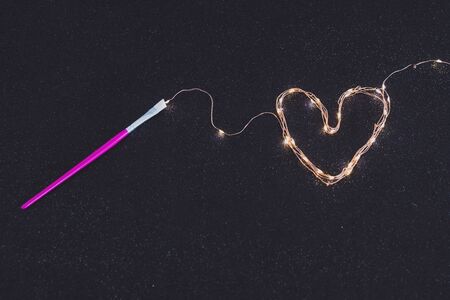 paintbrush painting with light with a set of string led lights, surreal still-life concept about...