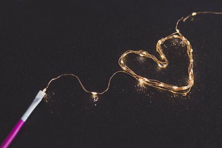 paintbrush painting with light with a set of string led lights, surreal still-life concept about creativityの写真素材