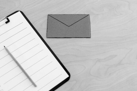 inbox stress concept, email miniature next to blank to do checklist on office desk