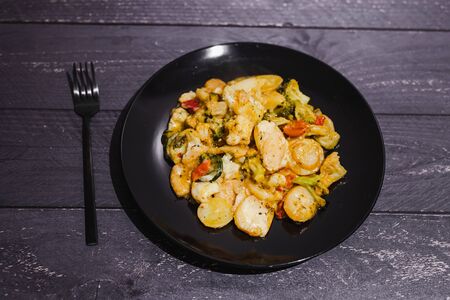 plant-based potato and veggies bake with vegan cheese topping and herbs, concept of healthy food...