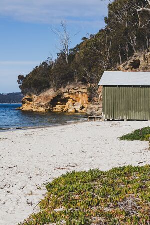 HOBART, AUSTRALIA - September 9th, 2019: view of Conningham Beach in Tasmania with its pristine rugged coastal beauty and the typical beach hutsのeditorial素材