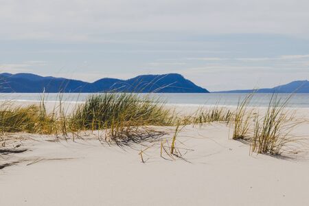 sunny pristine and deserted beach overlooking the South Pacific Ocean in Marion Bay along the East Coast of Tasmania Australiaの写真素材
