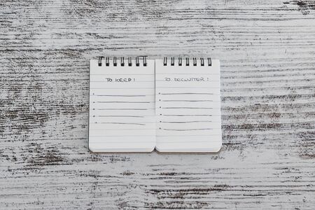 concept of minimalism and tidying up, mini notepads with To Keep and To Declutter lists