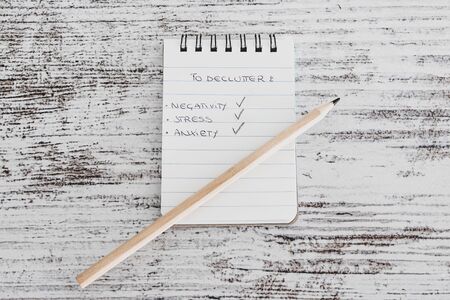 concept of minimalism and tidying up, mini notepads with To Keep and To Declutter lists 