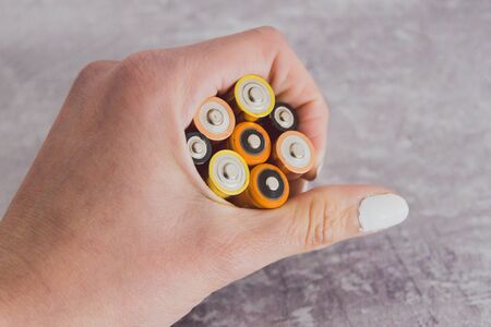 concept of energy and recycle, hand holding group of alkaline batteriesの写真素材