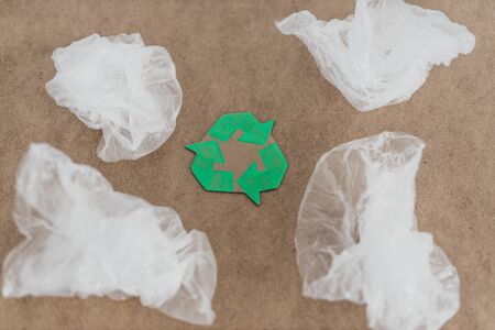 ecology and single-use plastic pollution concept, group of plastic bags with green recycle symbolの写真素材
