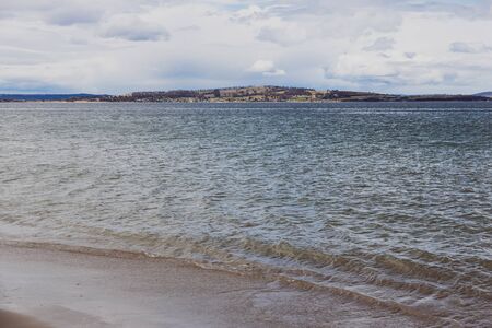 pristine Australian coastline and beach landscape with blue Pacific Ocean water and golden sand in...