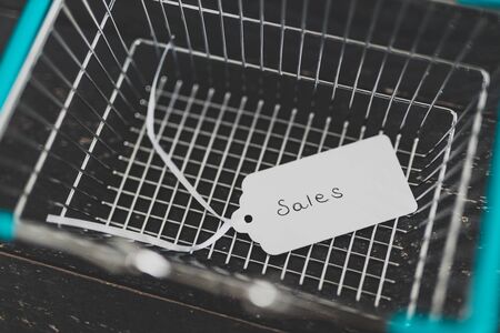 sales strategy and customer purchases, shopping basket with price tag with Sales written on itの写真素材