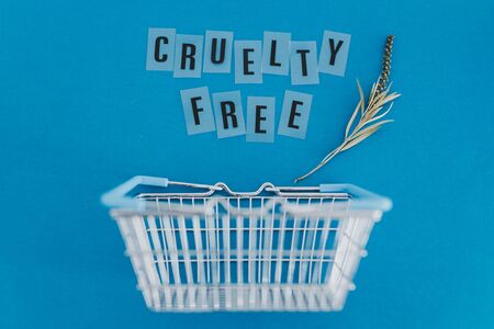 conscious consumer choices for animal rights conceptual illustration, shopping basket with leaves and Cruelty free text metaphor of vegan and eco-friendly products and dietの写真素材