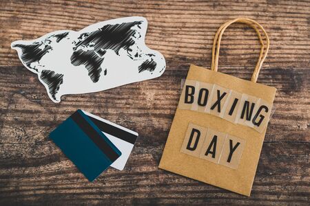 global marketing and promotional offers conceptual still-life, Boxing day shopping bag next to world...