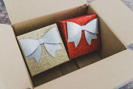 festive Christmas shopping online conceptual still-life, presents or gift boxes inside delivery parcelの写真素材
