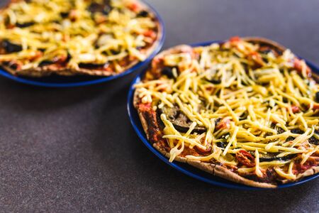 home cooking and meal prepping concept, vegetables pizzas with vegan cheddar topping