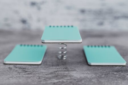 concept of uniqueness and being proactive, group of memo pads with one of them popping up on a...