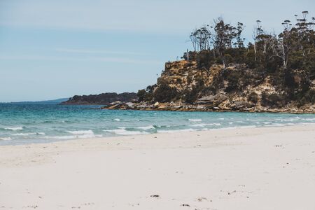 Spring beach in Tasmania, Australia looking pristine and deserted with white sand and turquoise water of the South Pacifc Oceanの写真素材