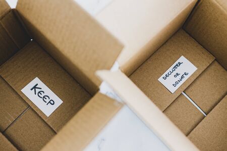 decluttering and tidying up conceptual still-life, white storage boxes to sort between objects to...