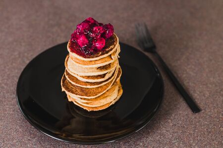 healthy plant-based recipes concept, vegan banana pancakes stack with exotic dragonfruit coulis on topの写真素材