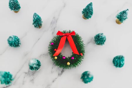 festive season's decorations conceptual still-life, group of miniature Christmas trees with wreath...