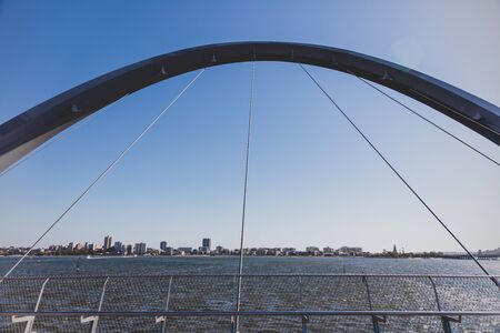 PERTH, WESTERN AUSTRALIA - December 24th, 2019: Elizabeth Quay's pedestrian bridge over the bay and...