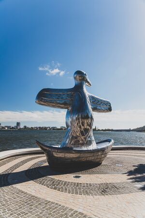 PERTH, AUSTRALIA - January 2nd, 2020: outstanding artwork First COntact by Laurel Nannup representing a bird in a boat recently installed in Elizabeth Quay in Perth CBDのeditorial素材