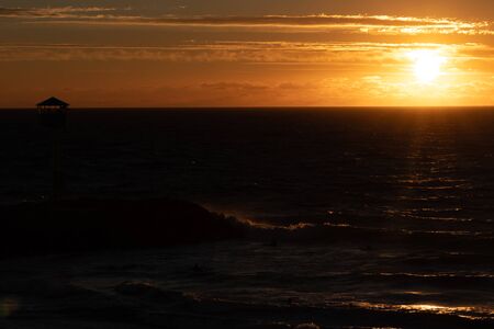PERTH, WESTERN AUSTRALIA - January 8th, 2020: view of the sunset over the Indian Ocean at City Beach, one of the most popular beaches near Perth on a warm summer dayのeditorial素材