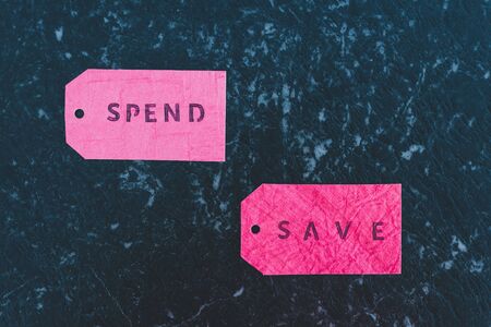 budgeting and managing your finance conceptual still-life, Spend vs Save texts on price tagsの写真素材