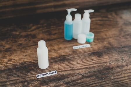 minimalist vs hoarder lifestyle conceptual still-life, one beauty product essential vs group with different types of lotions and moisturizersの写真素材