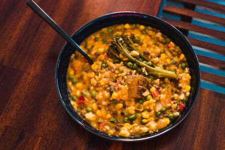 healthy plant-based recipes concept, yellow curry rice with mixed veggies and tofu