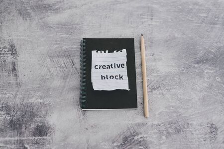 lack of inspiration or motivation conceptual still-life, scrunched paper with Creative Block text on...
