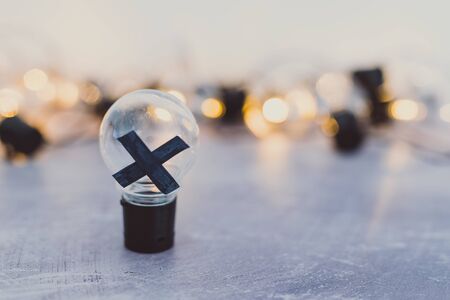 decision making conceptual still-life, bad idea rejected and crossed out surrounded by other light bulbs lit upの写真素材