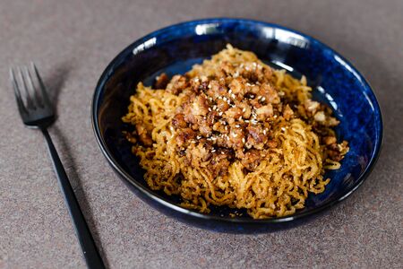 healthy plant-based recipes concpet, sticky ginger noodles with garlic vegan mince and sesame seeds