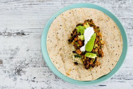 healthy blant-based recipes concept, beans rice and avocado open wrap with vegan aioliの写真素材