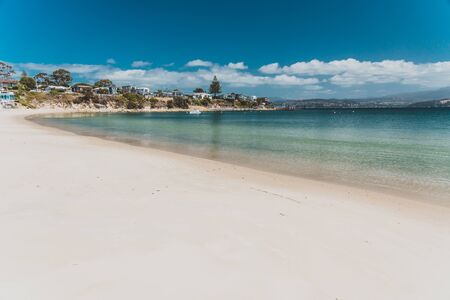 OPOSSUM BAY, TASMANIA - 16th February, 2020: view of Opossum Bay Beach on a sunny summer day with nobody on the beach with deep blue water and clear skies enhancing the beautiful coastline and shoresのeditorial素材