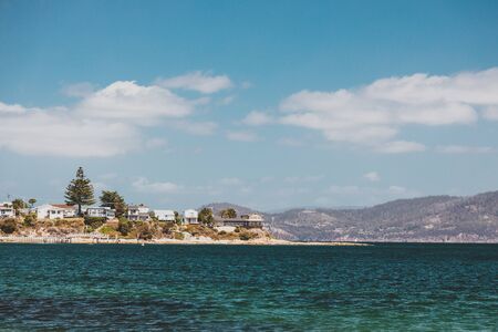 OPOSSUM BAY, TASMANIA - 16th February, 2020: view of Opossum Bay Beach on a sunny summer day with nobody on the beach with deep blue water and clear skies enhancing the beautiful coastline and shoresのeditorial素材