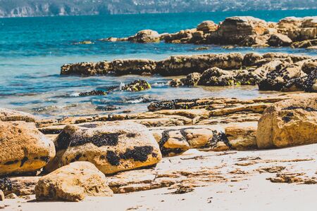 landscape in Opossum Bay Beach on a sunny summer day with nobody on the beach with deep blue water and clear skies enhancing the beautiful coastline and shoresの写真素材
