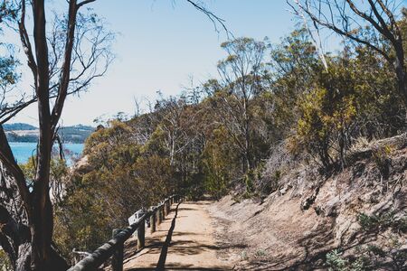 wild Tasmanian landscape and pristine turquoise water of the Derwent River as seen from Legacy Beach walking track near Coningham beach south of Hobartの写真素材
