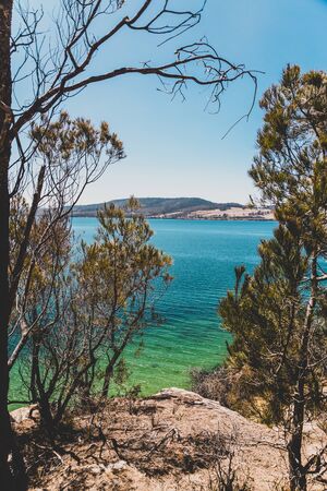 wild Tasmanian landscape and pristine turquoise water of the Derwent River as seen from Legacy Beach walking track near Coningham beach south of Hobartの写真素材