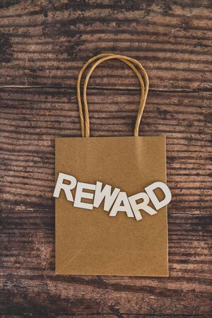 customer rewards and fidelization incentives conceptual still-life, shopping bag with price tag with...