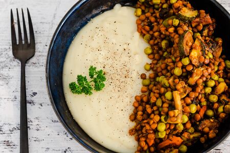 healthy plant-based food recipes, vegan lentils and potato mash dish with mixed veggies inspired by shepherd's pieの写真素材