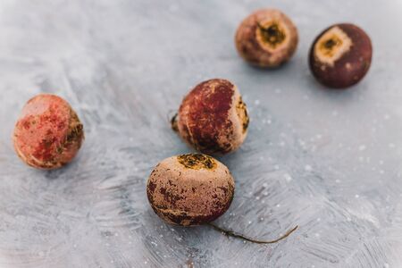 healthy ingredients for vegan meals, fresh raw beetroots with intense purple tones on greyの写真素材
