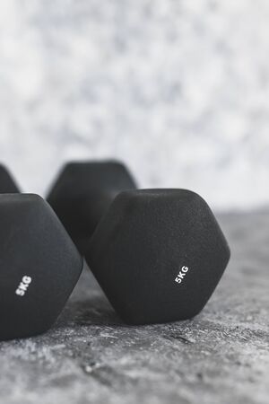 sport and fitness gear, set of black dumbbells on concrete shot at shallow depth of fieldの写真素材